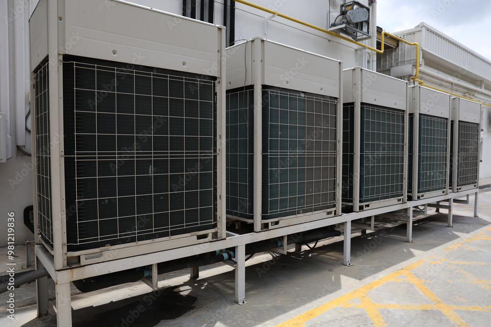 Fototapeta premium Air conditioner compressor installed in old building. Outdoor split wall type air conditioner compressor unit inverter installed on the outside of the building. Air conditioner compressor outdoor unit