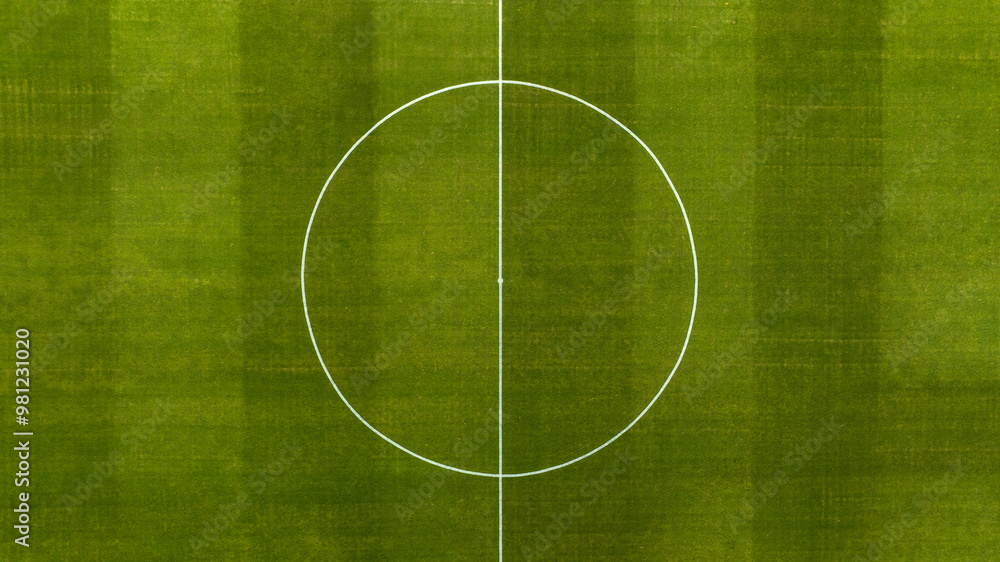 Aerial zenithal view on the center of a natural grass soccer field. Soccer stadium concept. Aerial zenithal view on the center of a natural grass soccer field. Soccer stadium concept.