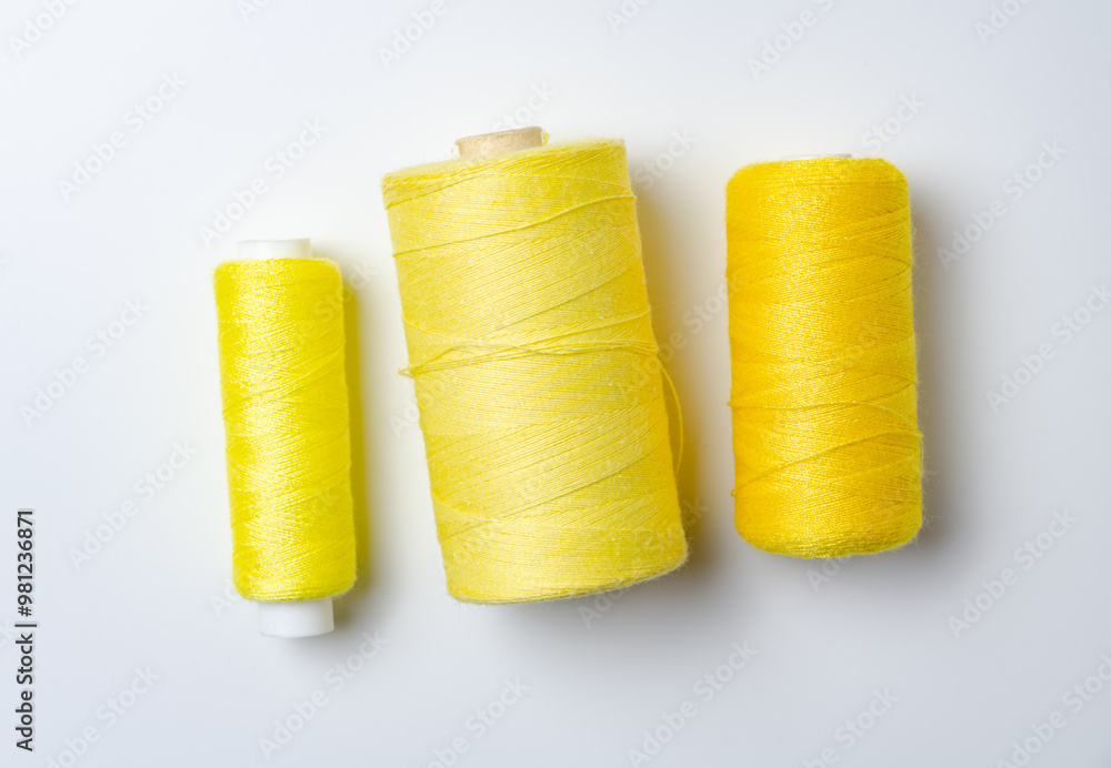 Yellow thread spools on white background. Yellow thread spools on white background.