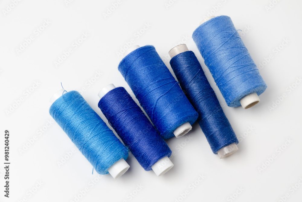 Blue thread spools on white background. Blue thread spools on white background.