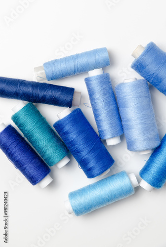 Blue thread spools on white background.