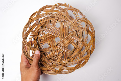 Piring Lidi. plates made from woven sticks (rattan plates) with a plain white background photo