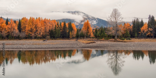 Quiet, calm autumn river. Dark atmospheric panoramic view