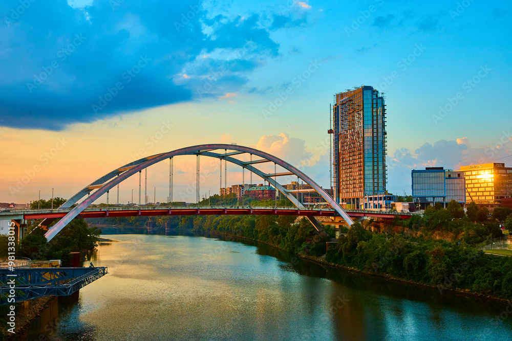 Naklejka premium Modern Bridge and Skyscraper at Golden Hour Nashville Riverfront Eye-Level