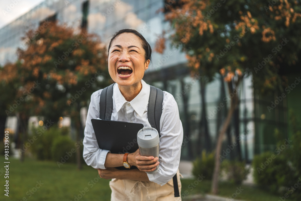 Mature japanese woman walk with backpack thermos and clipboard outdoor