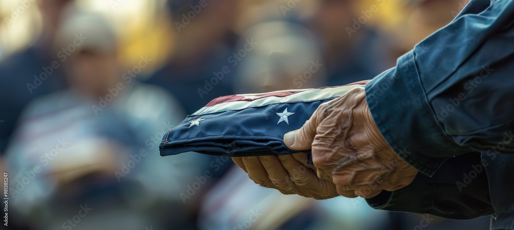 Veteran Holding Folded American Flag During Veterans Day Memorial Service with Blurred Crowd Veteran Holding Folded American Flag During Veterans Day Memorial Service with Blurred Crowd