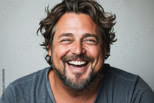 Studio portrait of mature man laughing in studio on white background.