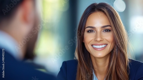 A woman with a smile on her face is talking to a man