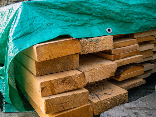 A stack of boards covered from precipitation with an awning