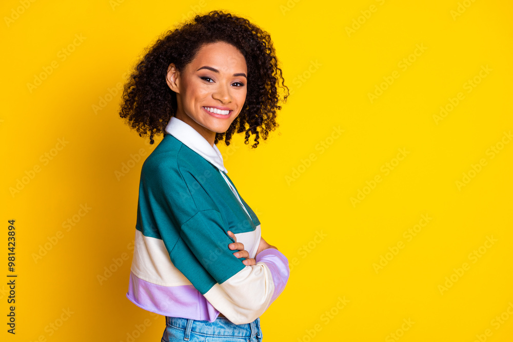 Photo portrait of attractive young woman crossed arms confident profile dressed stylish striped clothes isolated on yellow color background Photo portrait of attractive young woman crossed arms confident profile dressed stylish striped clothes isolated on yellow color background