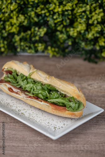 Obraz na płótnie sandwich with serrano or prosciutto ham and arugula w salonie