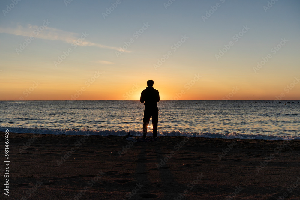 couple walking on the beach at sunset couple walking on the beach at sunset