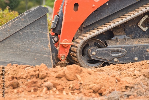 Orange construction vehicle sitting in a construction zone