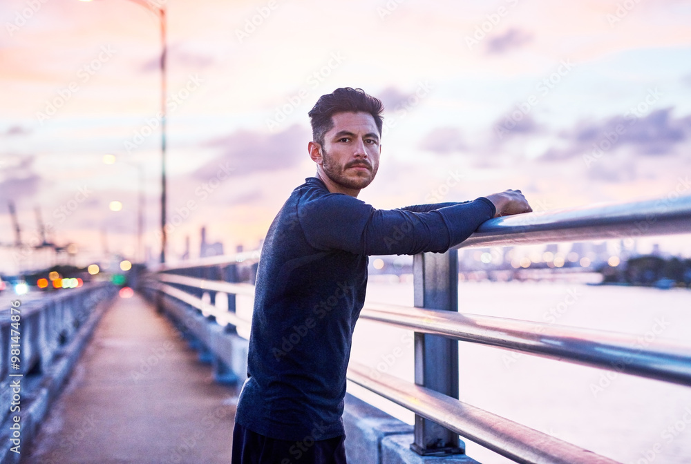 Fototapeta premium Man, portrait and sunrise on city bridge with sport, athlete and fitness break for training in the morning. Exercise, urban and confidence by the road ready for run and marathon at dawn in New York