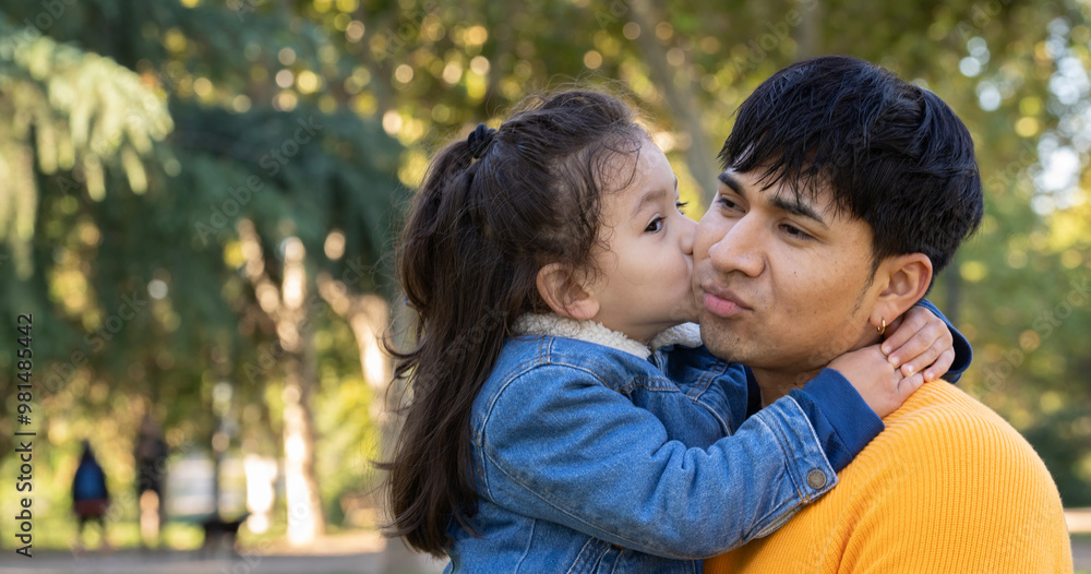 Headshot of hispanic father showing love , kissing and hugging outdoors with copy space Headshot of hispanic father showing love , kissing and hugging outdoors with copy space