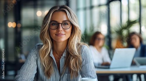 Confident woman in glasses at modern workspace