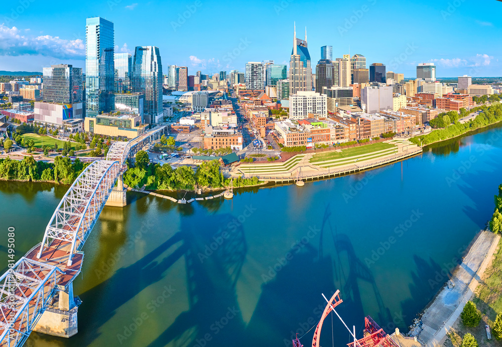 Fototapeta premium Aerial Panorama of Nashville Skyline and Cumberland River with Pedestrian Bridge