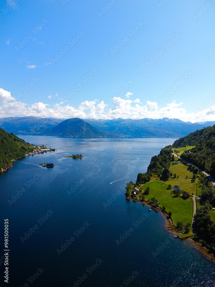 Naklejka premium Stunning Aerial View of a Serene Lake, Beautifully Surrounded by Majestic Mountains