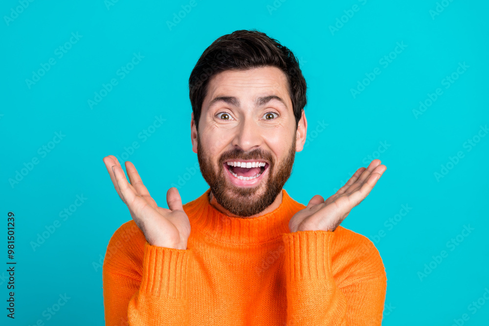 Photo of cheerful positive handsome man wear orange trendy clothes good mood isolated on cyan color background Photo of cheerful positive handsome man wear orange trendy clothes good mood isolated on cyan color background