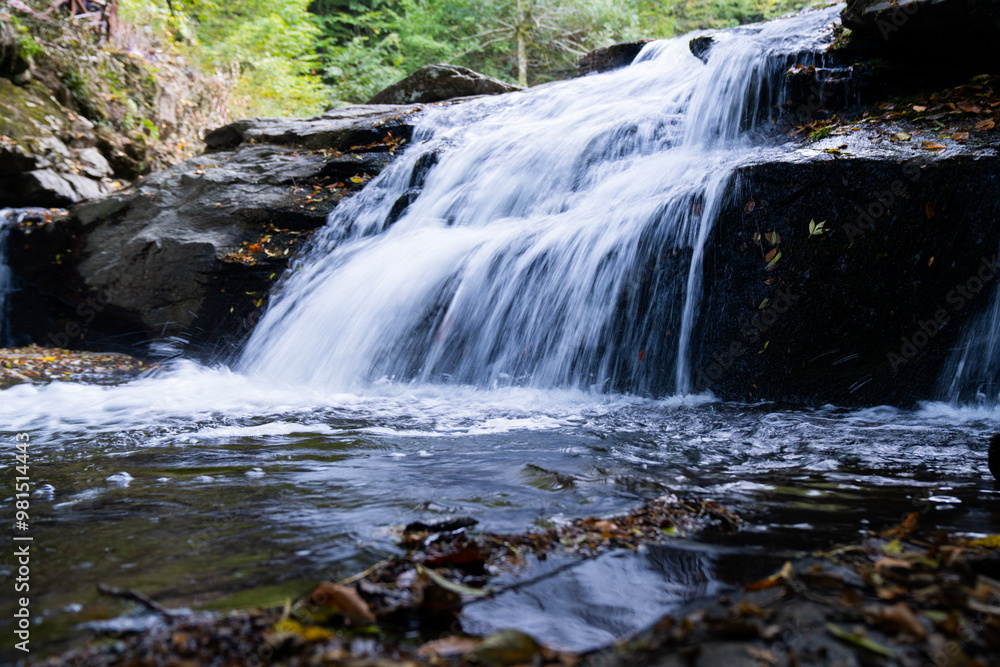 Obraz premium long exposure of waterfall flowing between rocks