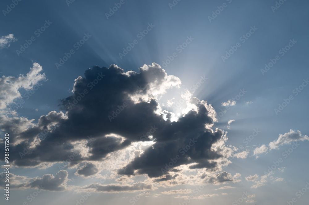 Sun behind a cloud with rays of light Sun behind a cloud with rays of light
