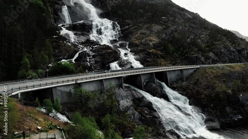 The great Langfoss waterfall drops 600 meters down to the fjord below. Driving alongside Åkrafjorden, it is impossible to miss Langfoss waterfall. View from a drone. photo