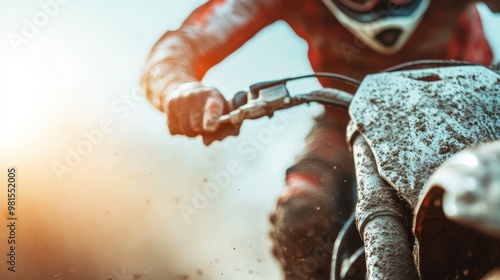 A motocross rider in vibrant gear maneuvers through a dirt bike course, exuding energy and control. The image captures the gritty and exhilarating spirit of motocross racing. photo