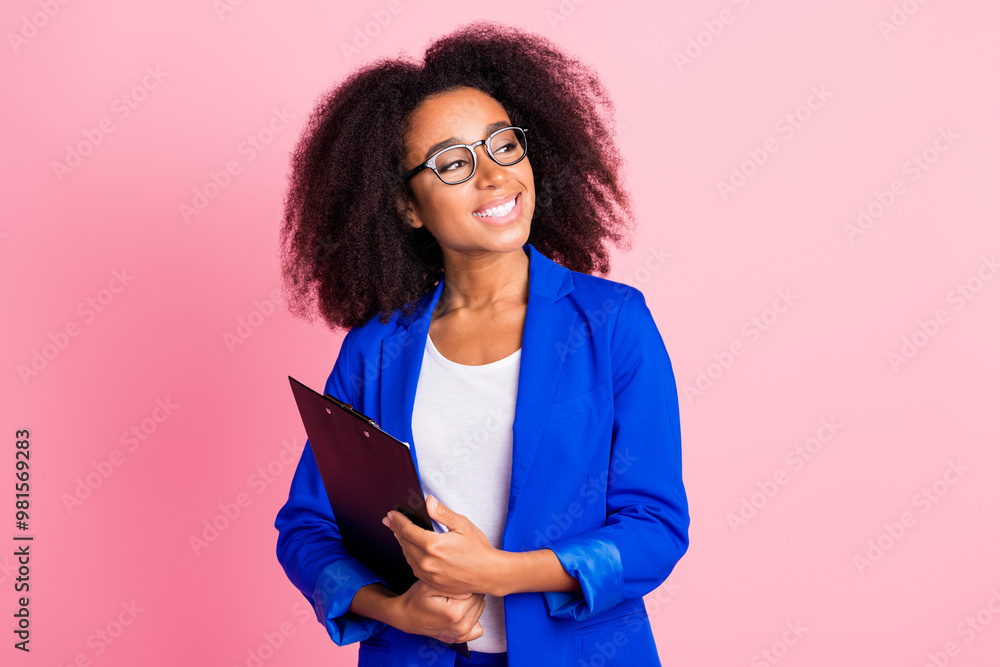 Photo of adorable pretty girl wear stylish blue clothes hold notepad look empty space isolated on pink color background Photo of adorable pretty girl wear stylish blue clothes hold notepad look empty space isolated on pink color background