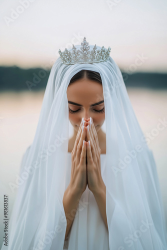 A woman wearing a white veil and a crown of flowers