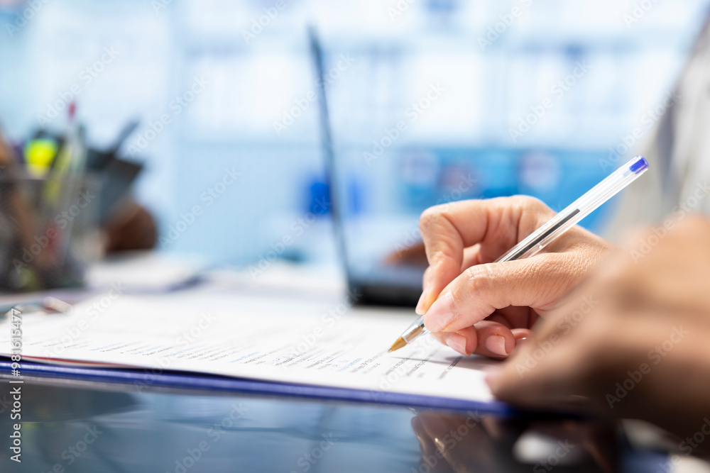 Physician writing a prescription treatment plan to help with recovery, recommending a suitable healthcare strategy based on radiography results and hospital records. Medicare meeting. Close up. Physician writing a prescription treatment plan to help with recovery, recommending a suitable healthcare strategy based on radiography results and hospital records. Medicare meeting. Close up.