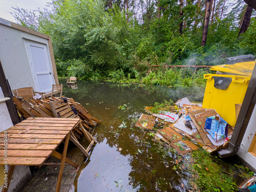 Flooded Backyard Area With Debris and Standing Water Near a Storage Shed in a Wooded Environment Flooded Backyard Area With Debris and Standing Water Near a Storage Shed in a Wooded Environment
