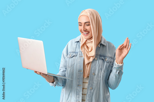 Young Muslim woman with lap...