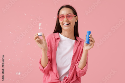 Young woman with soap bubbl...