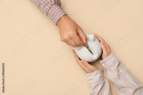Couple putting money into p...