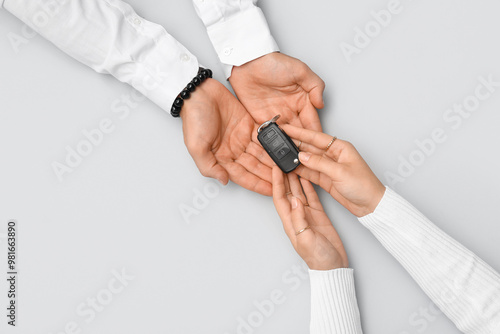 Couple with car key on ligh...