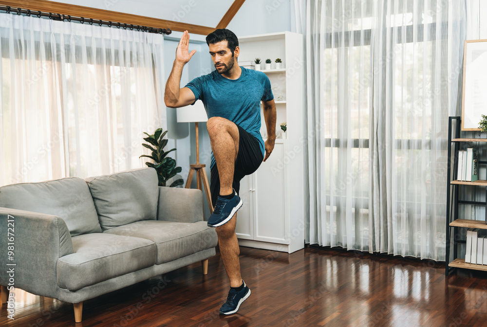 Athletic and sporty man running posture at home body workout exercise session for fit physique and healthy sport lifestyle at home. Gaiety home exercise workout training. Athletic and sporty man running posture at home body workout exercise session for fit physique and healthy sport lifestyle at home. Gaiety home exercise workout training.