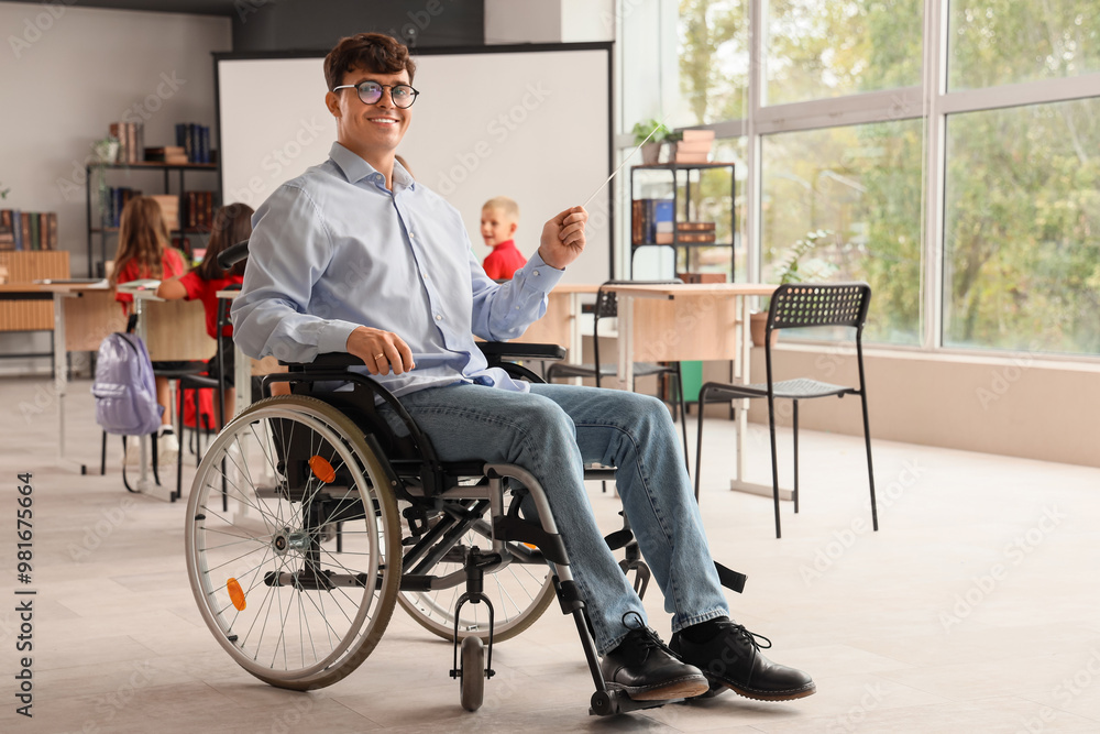 Male teacher in wheelchair with pointer at school Male teacher in wheelchair with pointer at school