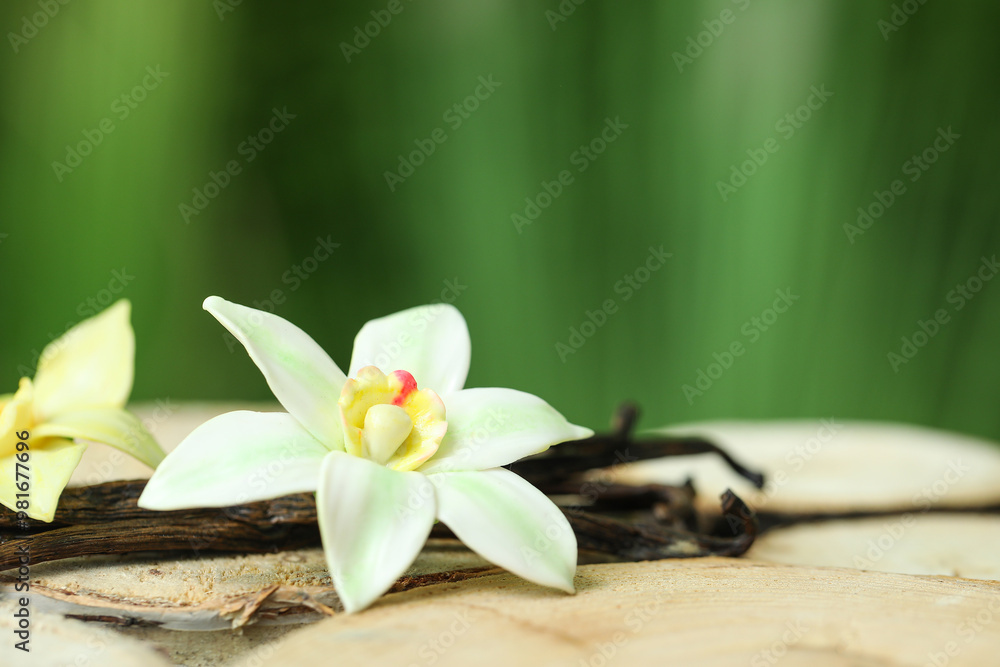 Aromatic vanilla pods and flowers on table outdoors Aromatic vanilla pods and flowers on table outdoors