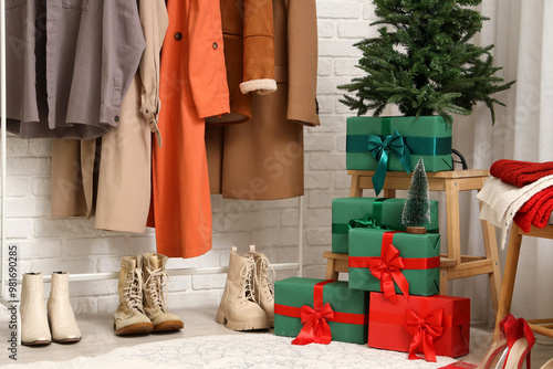 Interior of hallway with Christmas tree, presents and clothes rack