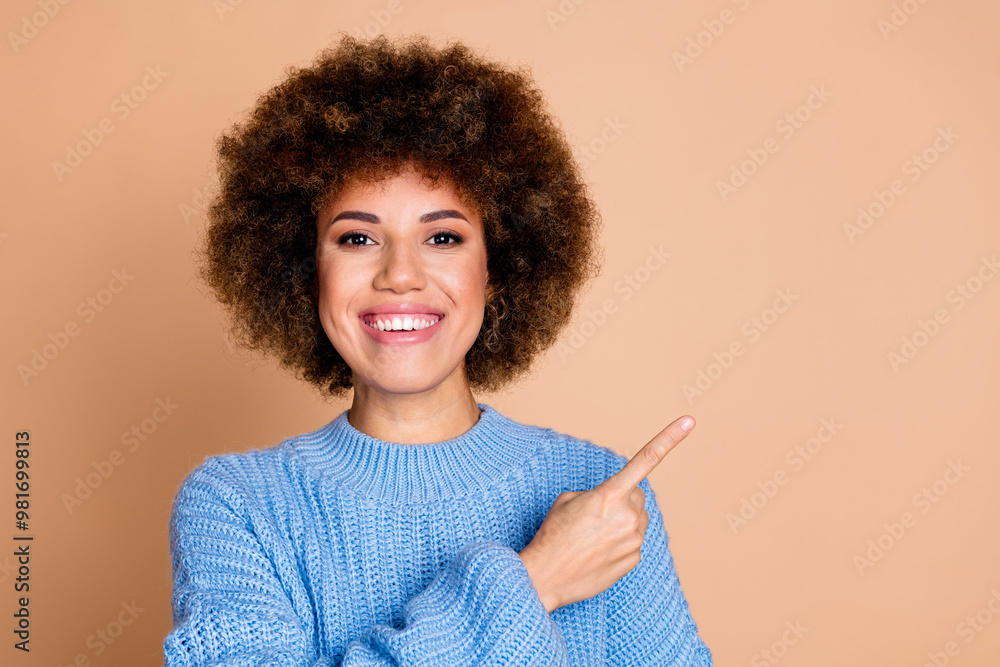 Photo of positive girl with chevelure dressed blue knit sweater directing at discount empty space isolated on pastel color background Photo of positive girl with chevelure dressed blue knit sweater directing at discount empty space isolated on pastel color background