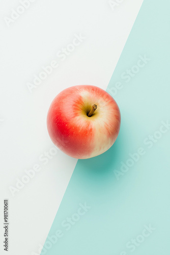 Top view of an apple on a white and light blue background, with hard shadows, in a minimalist style. This is a studio photography product shot with bright light, sharp focus, and professional 