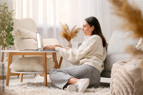 Young woman using laptop on...