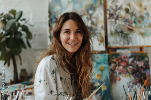Joyful woman painting a vibrant scene on a blank canvas