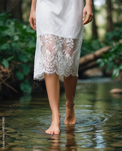 A woman stands barefoot in a quiet forest stream, symbolizing a deep connection to nature (14) photo