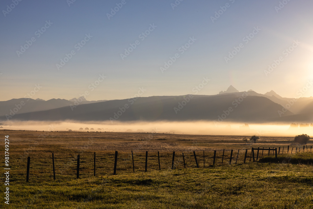 Obraz premium Photograph of beautiful peaceful foggy morning on a ranch in Idaho Grand Teton Mountains on the horizon