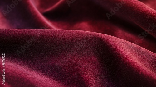 Closeup of red fabric with subtle texture and folds.