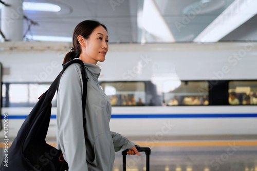 Young Woman in Airport Train Station with Luggage Ready to Board photo