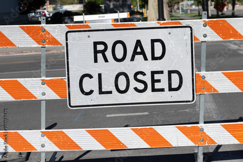 Photograph of road closed signage sitting on urban street