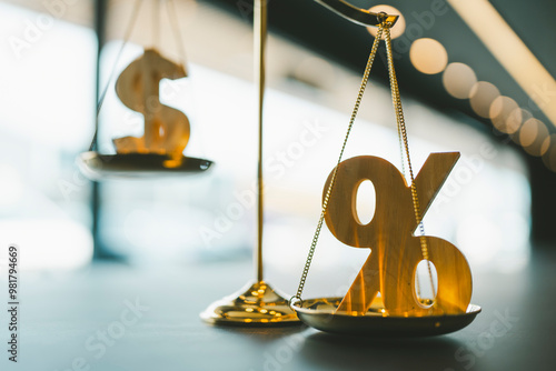 A picture of a balance scale with a dollar sign and a percentage sign together, the idea that the value determined by interest rates going up or down is more important than the actual value of money. photo