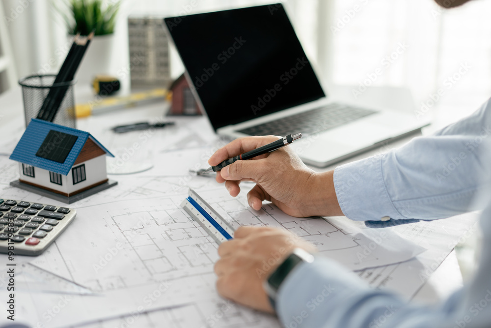 Architect working drawing draft on blueprints in the office, working with modern house blueprint floorplans, architectural and construction project concept. Architect working drawing draft on blueprints in the office, working with modern house blueprint floorplans, architectural and construction project concept.